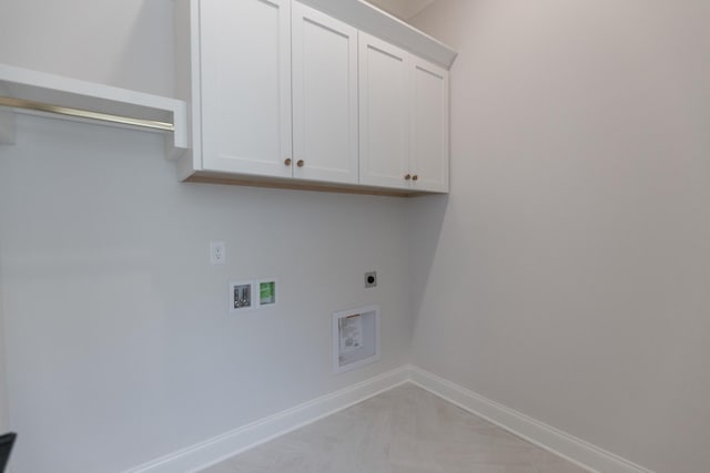 washroom featuring cabinet space, electric dryer hookup, baseboards, and washer hookup