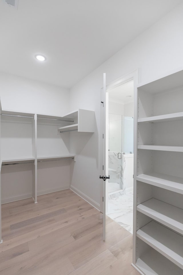 spacious closet with visible vents and light wood-type flooring