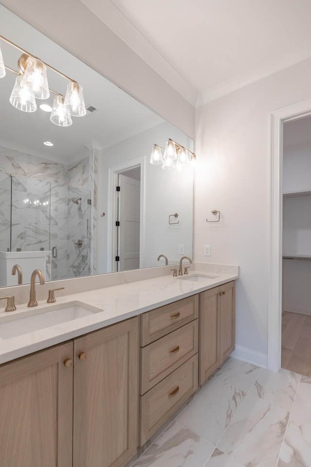 bathroom featuring marble finish floor, a sink, a marble finish shower, double vanity, and baseboards