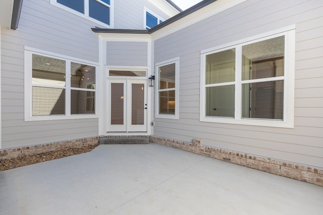 property entrance featuring a patio area