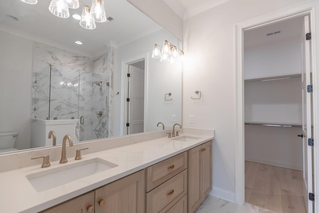 full bath featuring baseboards, marble finish floor, a marble finish shower, and a sink