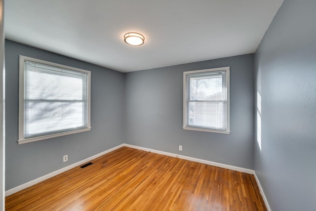 empty room with light hardwood / wood-style floors