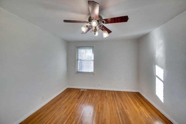 empty room featuring light wood-type flooring and ceiling fan