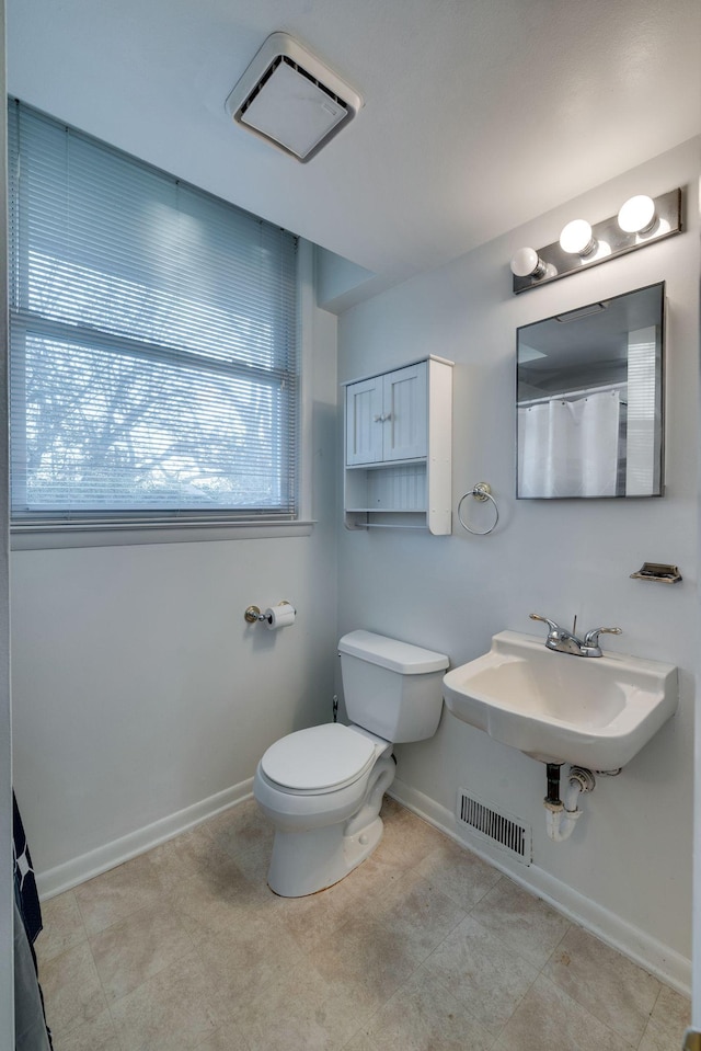 bathroom with tile patterned flooring, toilet, and sink