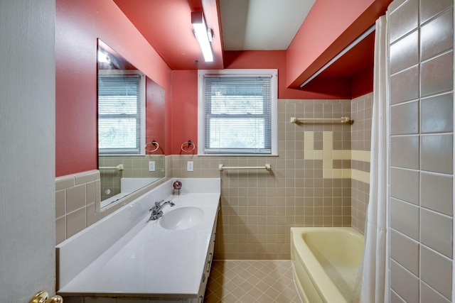 bathroom with vanity, plenty of natural light, and tile walls