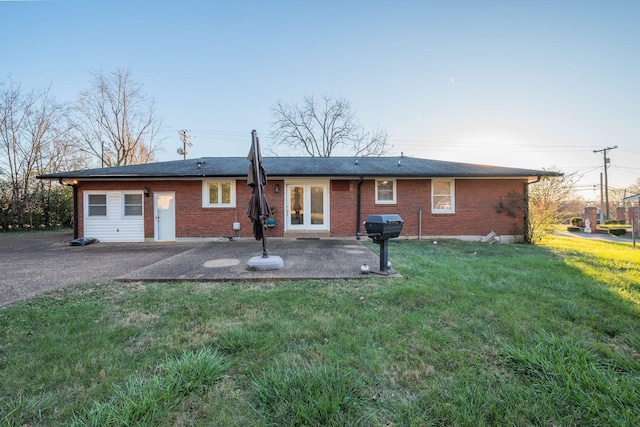 back of house with a yard, a patio area, and french doors