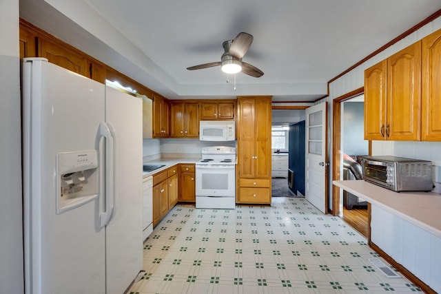 kitchen featuring ceiling fan, white appliances, and sink