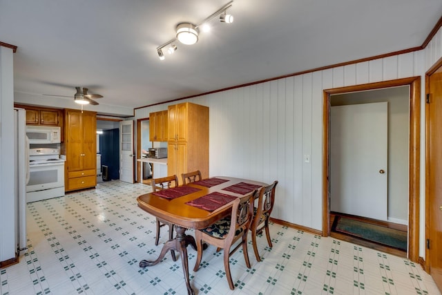 dining area with crown molding and ceiling fan