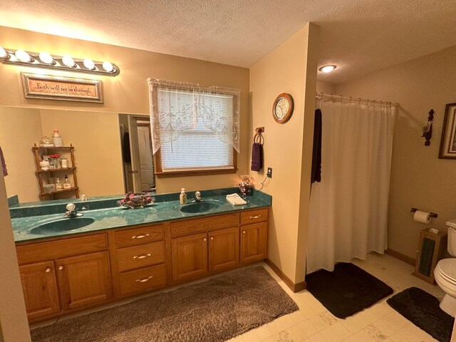 bathroom with vanity, a textured ceiling, toilet, and a shower with shower curtain