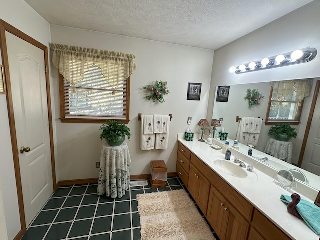 bathroom with vanity and a textured ceiling