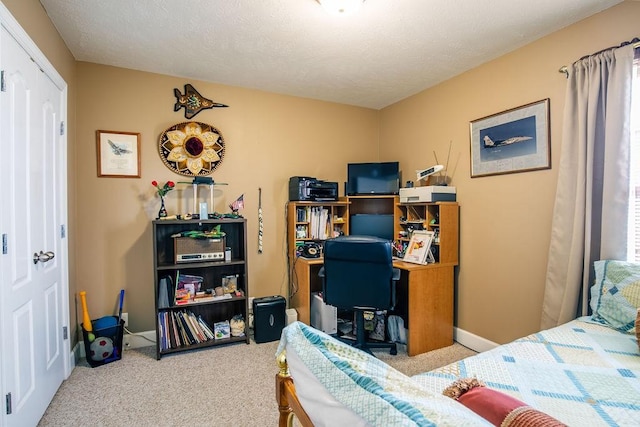 carpeted bedroom with a textured ceiling and a closet