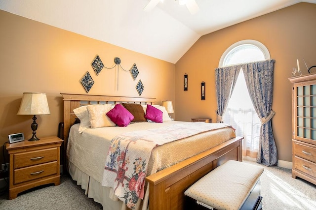 carpeted bedroom with ceiling fan and vaulted ceiling