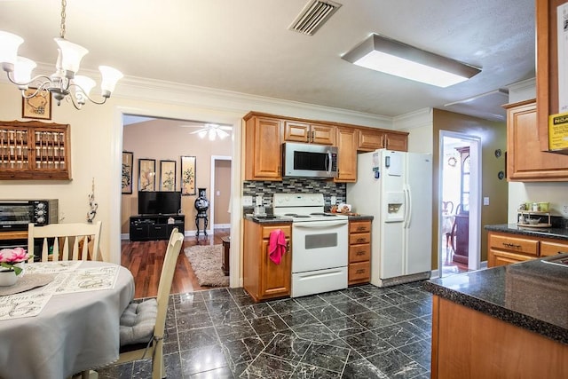 kitchen with pendant lighting, white appliances, crown molding, dark hardwood / wood-style floors, and tasteful backsplash