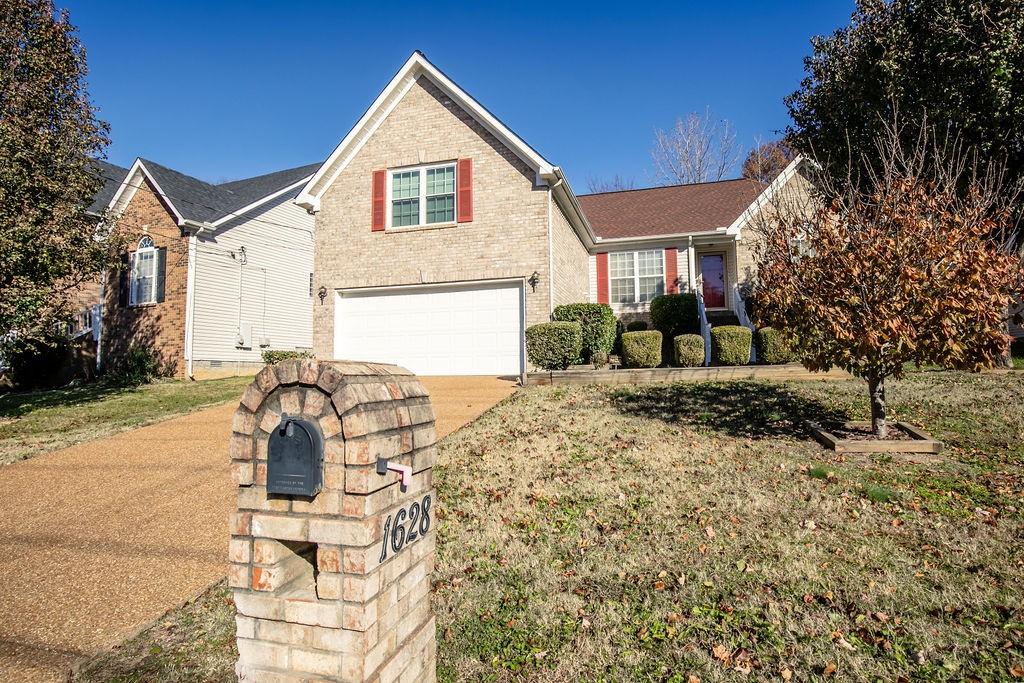 view of front property with a front yard and a garage