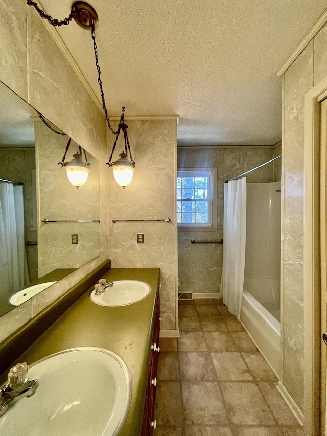 bathroom featuring vanity, shower / tub combo, and a textured ceiling