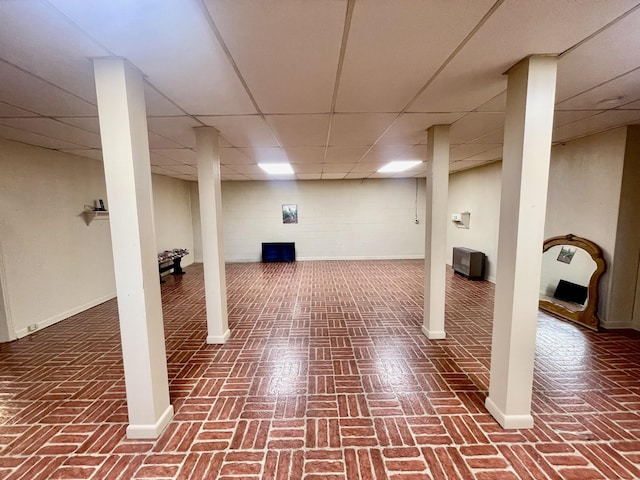 basement featuring a paneled ceiling