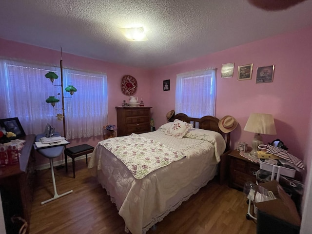 bedroom with wood-type flooring and a textured ceiling