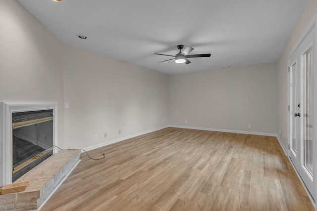 unfurnished living room featuring ceiling fan and light hardwood / wood-style flooring