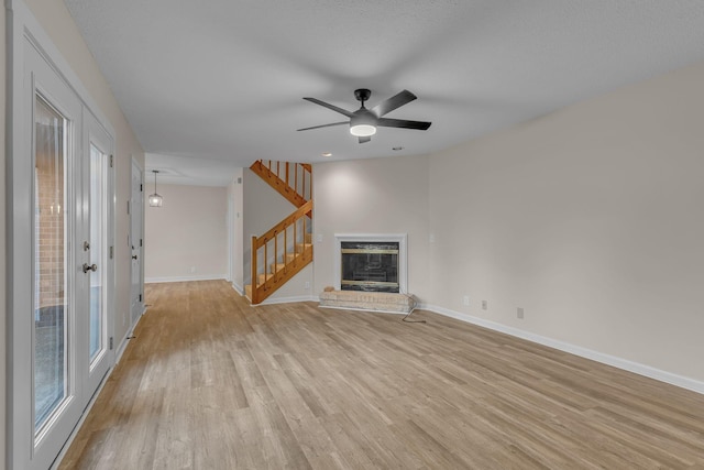 unfurnished living room featuring ceiling fan and light hardwood / wood-style flooring