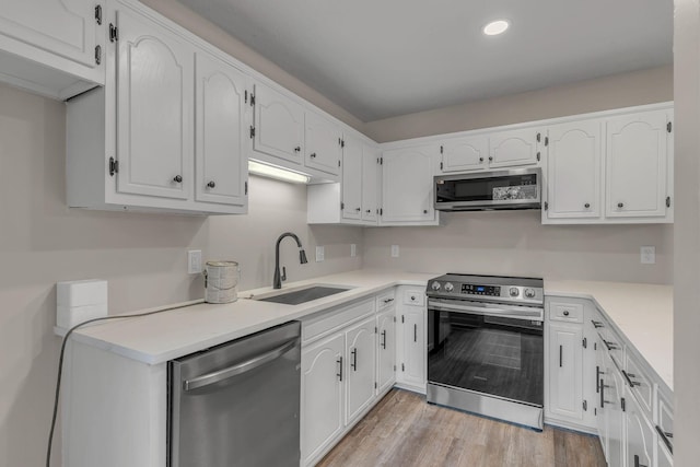 kitchen with white cabinetry, sink, and appliances with stainless steel finishes