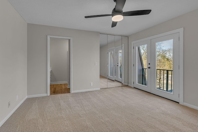 interior space with ceiling fan, access to exterior, light colored carpet, and french doors