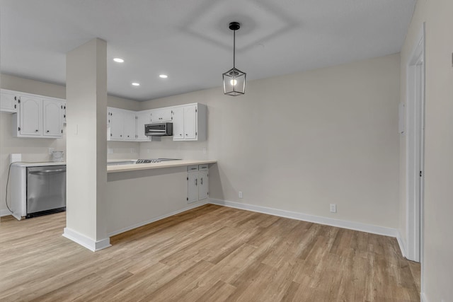 kitchen with white cabinets, pendant lighting, light wood-type flooring, and appliances with stainless steel finishes