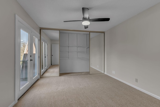 unfurnished bedroom with ceiling fan, a closet, light carpet, and french doors