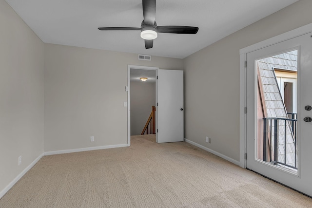 spare room with light carpet and ceiling fan