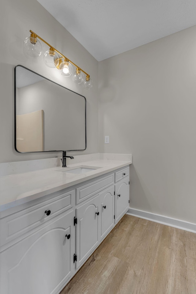 bathroom featuring hardwood / wood-style floors and vanity