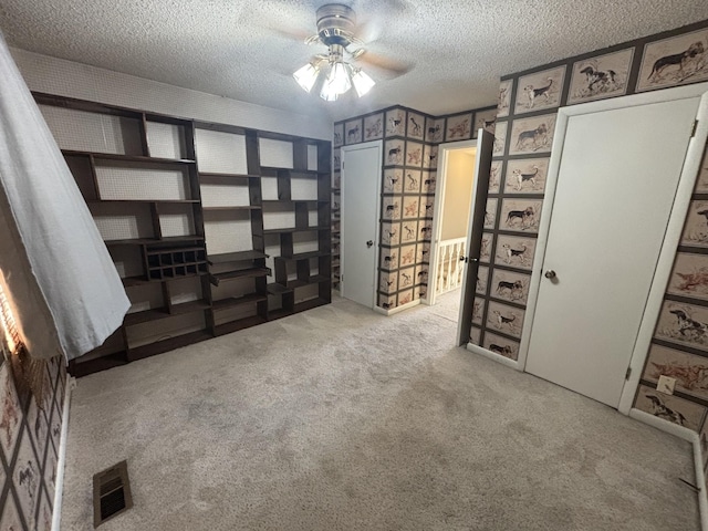 interior space with ceiling fan and light colored carpet