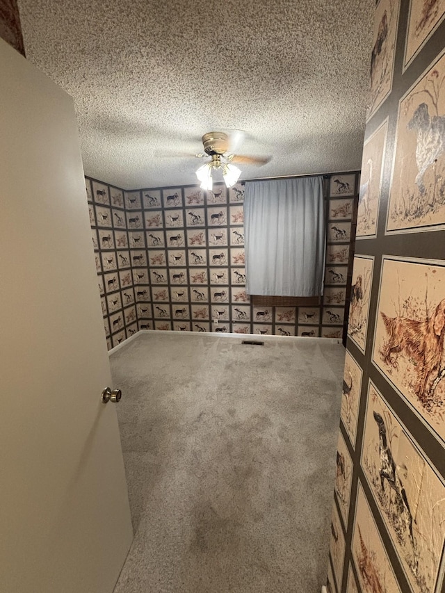 carpeted spare room featuring a textured ceiling