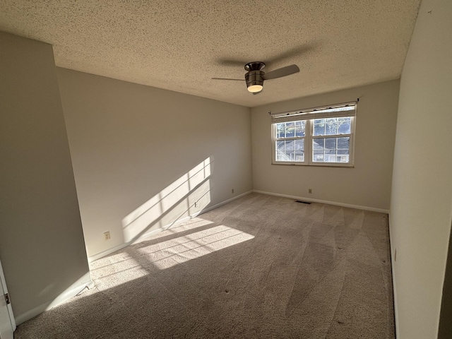 carpeted empty room featuring a textured ceiling and ceiling fan