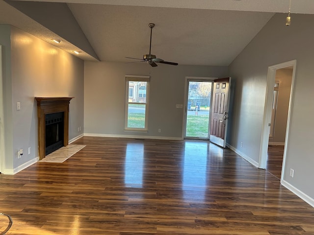 unfurnished living room with a textured ceiling, ceiling fan, high vaulted ceiling, and dark hardwood / wood-style floors