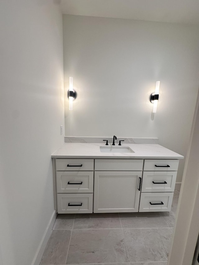 bathroom with vanity and baseboards