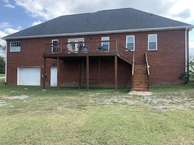 rear view of house featuring a yard, a deck, and a garage