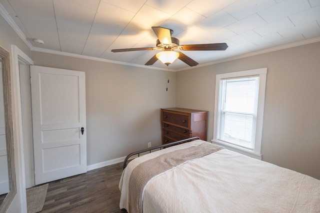 bedroom featuring dark hardwood / wood-style flooring, ceiling fan, and ornamental molding