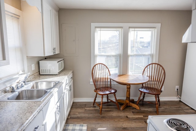 kitchen with white appliances, dark hardwood / wood-style floors, white cabinetry, and sink