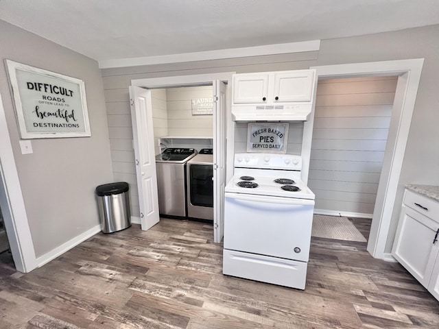 kitchen featuring white range with electric stovetop, washing machine and clothes dryer, dark hardwood / wood-style flooring, and white cabinets