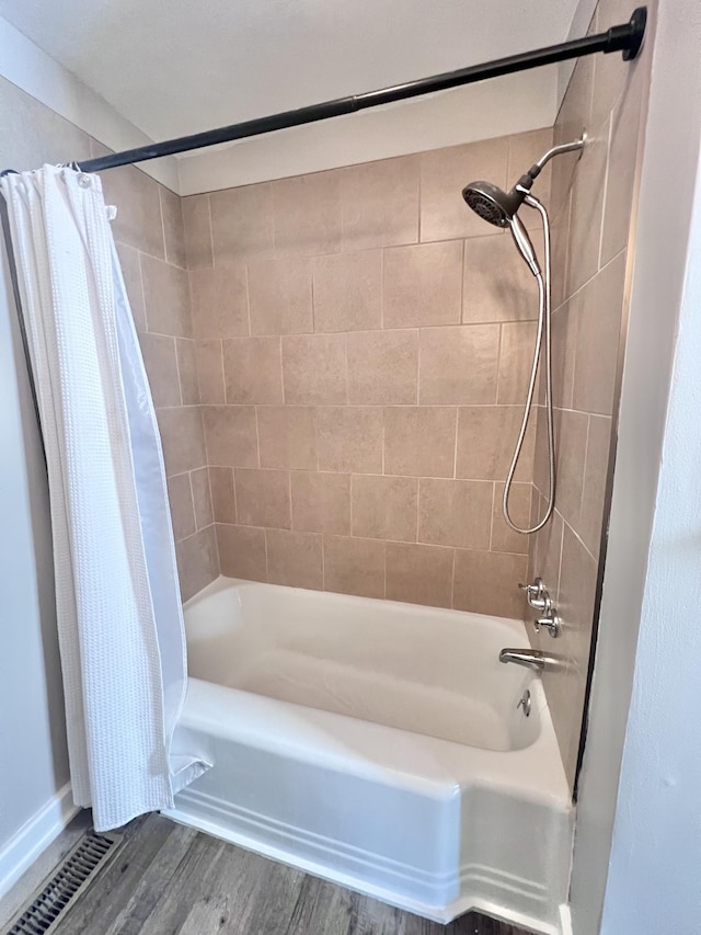 bathroom featuring shower / bath combo and wood-type flooring