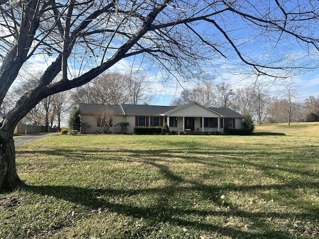 ranch-style home featuring a front yard