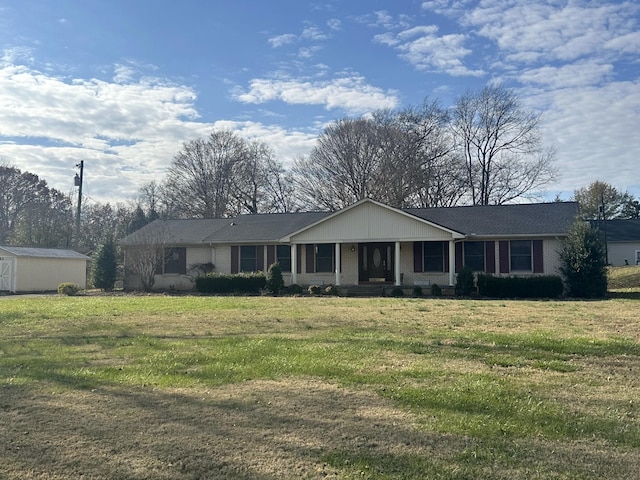 ranch-style house with covered porch and a front lawn