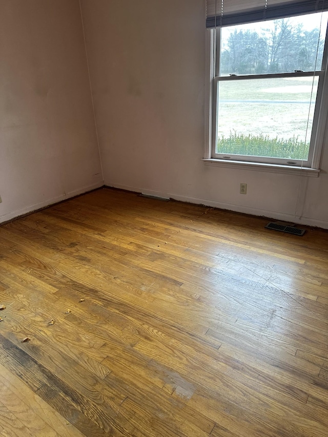 spare room with light hardwood / wood-style flooring