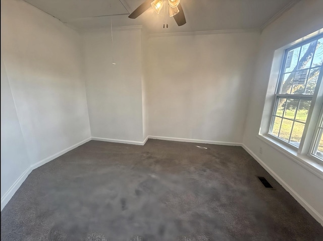 unfurnished room with dark carpet, ceiling fan, and ornamental molding