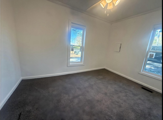 carpeted spare room with ceiling fan and crown molding