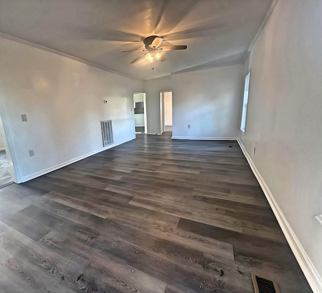 empty room with crown molding, ceiling fan, and dark wood-type flooring