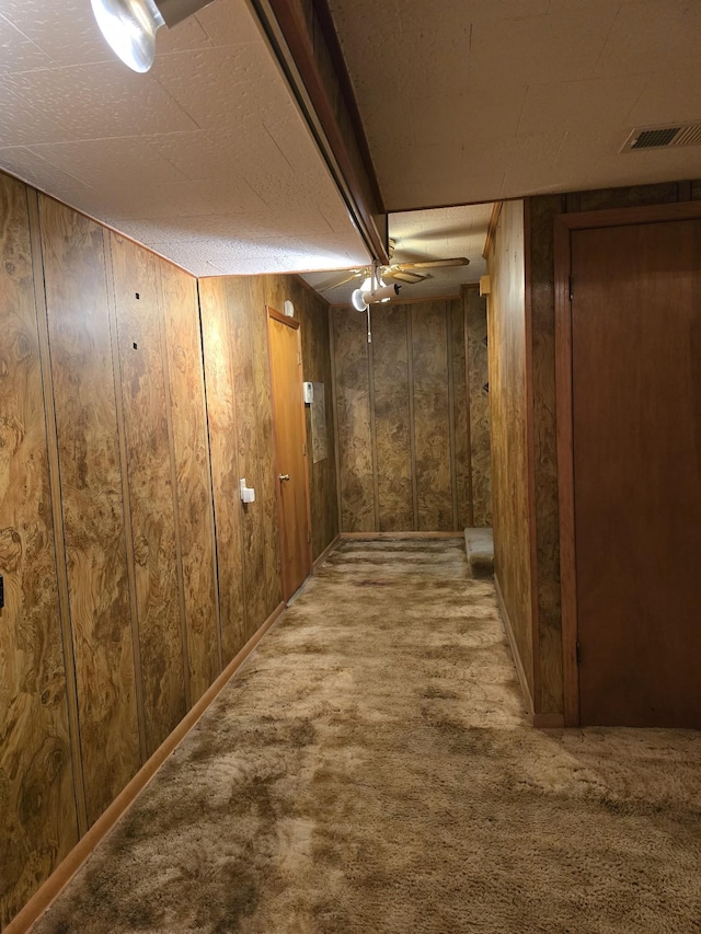 corridor with carpet and wood walls