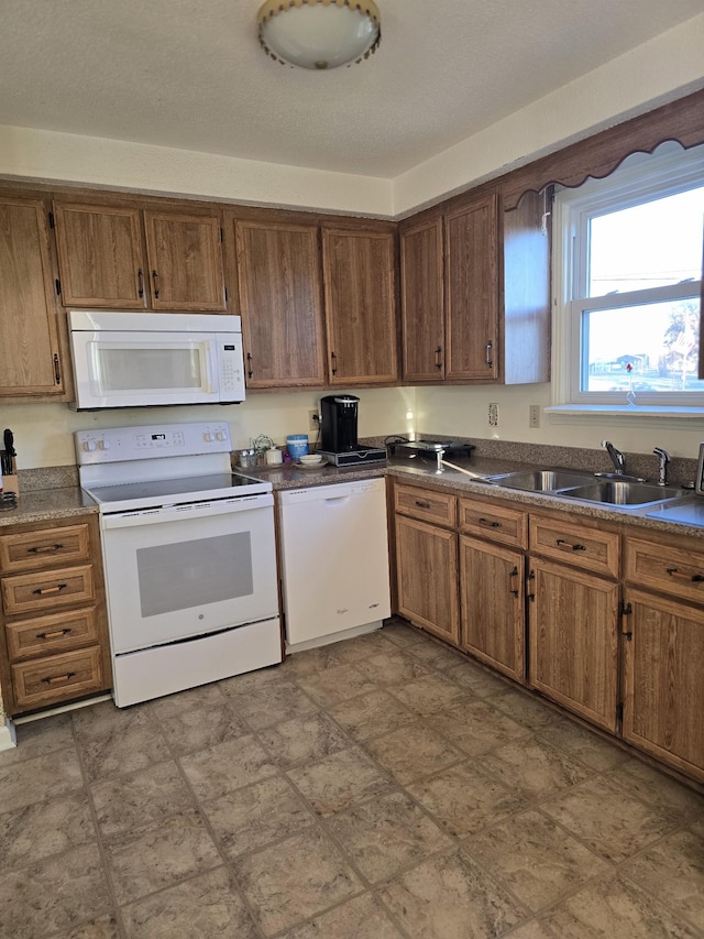 kitchen with white appliances and sink