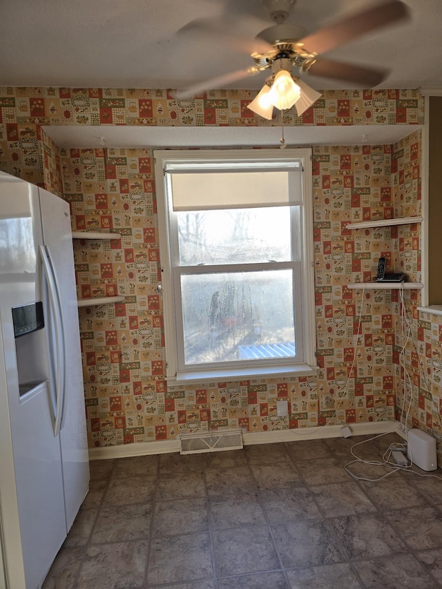 kitchen with white refrigerator with ice dispenser and ceiling fan