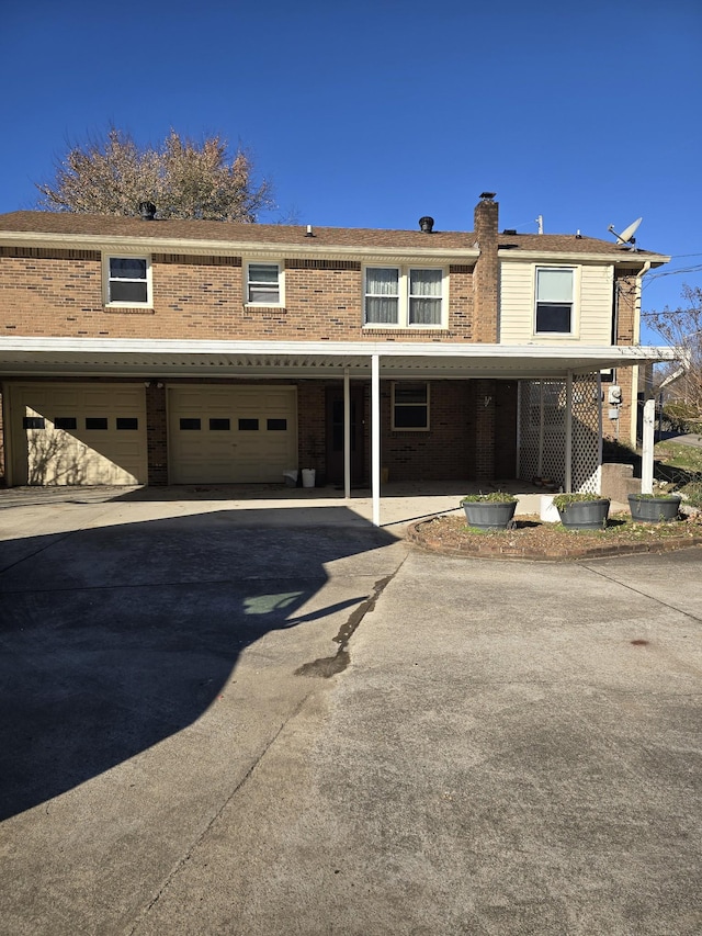 view of front facade with a garage and a carport