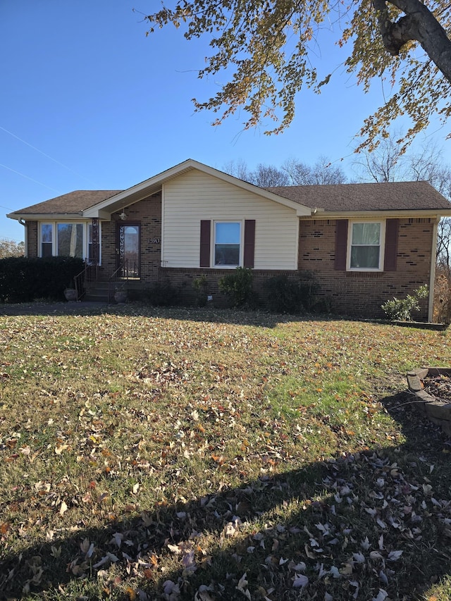 single story home featuring a front lawn